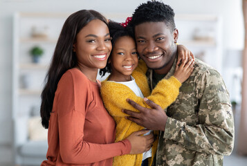 Military Family. Portrait Of African American Male Soldier With Wife And Daughter