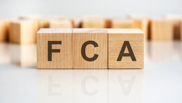 FCA - letters on wooden cubes. business as usual concept image. front view
