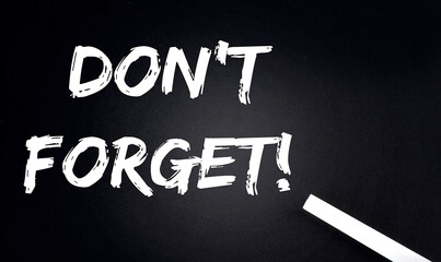 Don't Forget Text on Black Chalkboard with a piece of chalk