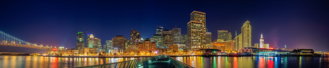 Fototapeta na wymiar San Francisco skyline night panorama with city lights on Pier 14
