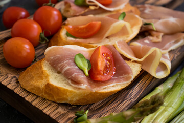 jamon sandwich, asparagus on old background