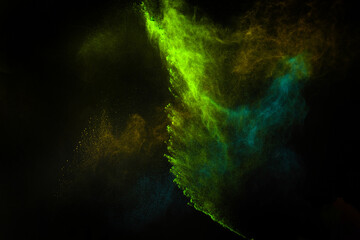 Freeze motion of colorful dust explosion on black background for Happy Holi