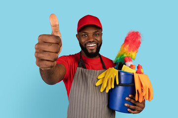 Cleaning Services. Black Cleaner Man Holding Basket With Detergents, Gesturing Thumb Up
