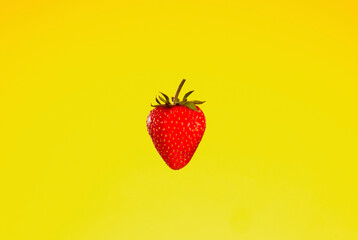 Fresh red strawberry on yellow background. Close up view