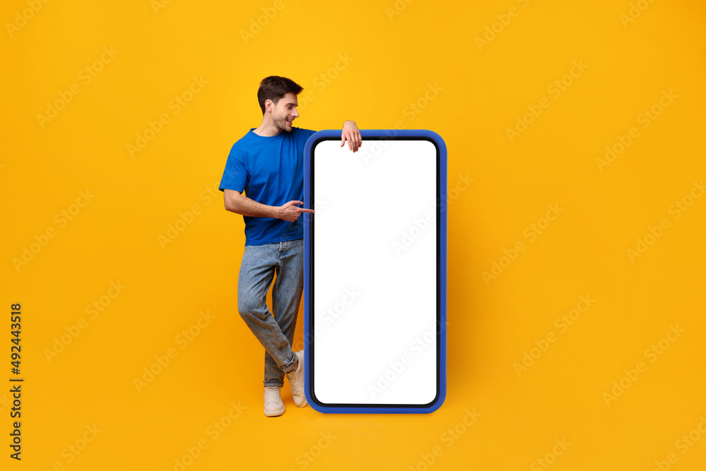 Poster guy pointing and leaning on big white empty smartphone screen