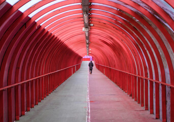 Man Walking Alone In A Covered Walkway