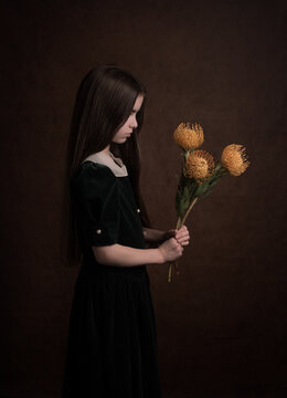 Renaissance portrait of a girl in classic dress holding yellow flowers in dark style