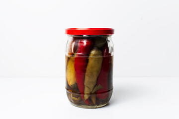 Jar of homemade canned chilli peppers isolated on  white background.
