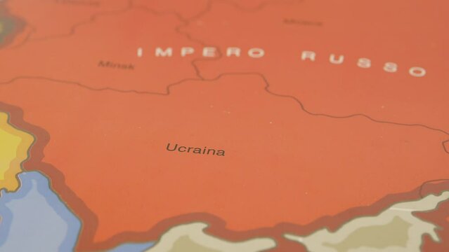 Geographic map illustrating the Russian and Ukrainian borders, Russian tanks attack Ukrainian territory, but hand sweeps them away, putting a peace flag in its place.
