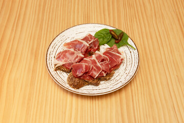 Garlic bread toast with grated tomato, Iberian ham and arugula, a very simple appetizer idea