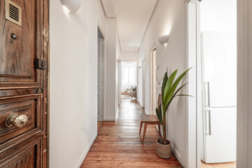 Entrance to a residential house with nobre pine floorboards with a paneled wooden door and a...