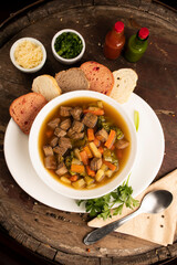 meat and vegetables soup top view with bread