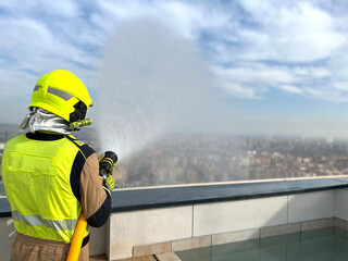Fototapeta premium firefighter spraying water fire fighting operation