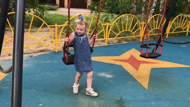 little girl on a swing