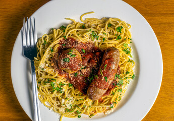 speghetti top sauce parsley and parmesan cheese