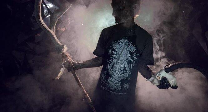 scary sorcerer in smoke. voodoo rite