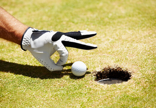 Just a little push. A golfer about to flick a ball into the hole.