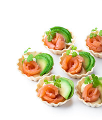 Tartlets with cream cheese and smoked salmon isolated on white