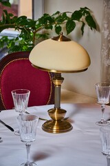 An old lamp stands on a table in a restaurant 