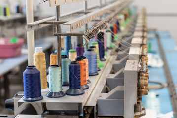 Variety of colors of different spools of thread to mass produce the embroidery art of this product