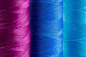 A skein of purple, blue and cyan thread. Waxed sewing thread for leather goods.