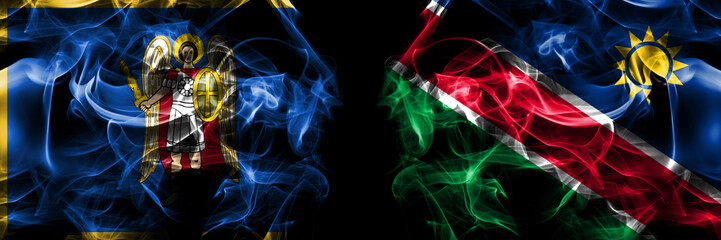 Kyiv, Kiev vs Namibia, Namibian flag. Smoke flags placed side by side isolated on black background.