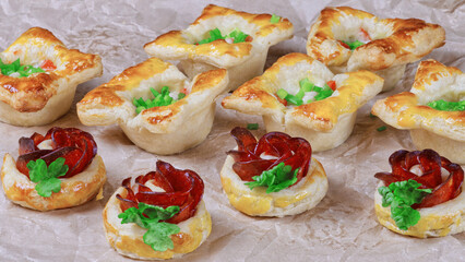 fresh homemade pastries. puff pastry appetizers mix. rose-shaped pepperoni cake. pastry with salami. close up