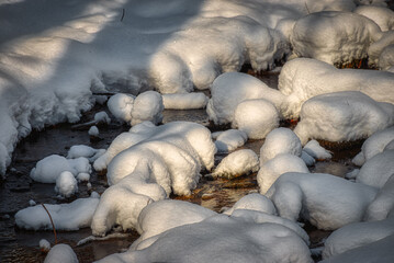 Snow on top of rocks in a small creek in Windsor in Upstate NY.  Last night's snow leaves the creek covered in several inches of snow.