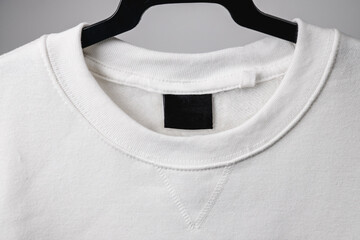 Empty black label on white sweatshirt for logo, size and info.