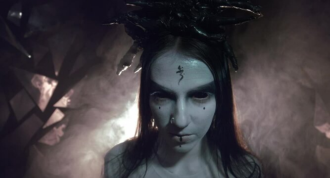 the sorceress stands in the smoke. voodoo rite
