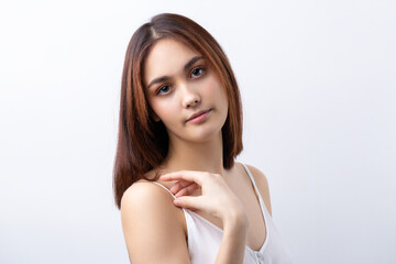 Beautiful smiling woman with clean skin, natural make-up and white teeth on a gray background