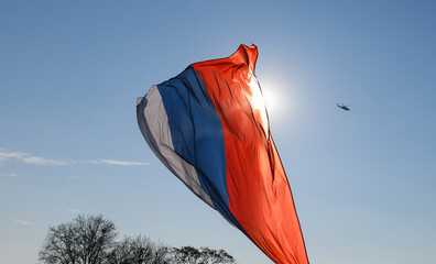 Russian flag on blue sky background