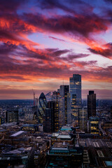 Obraz premium The highrise skyscrapers at the City of London during a colorful evening just after sunset, England, United Kingdom