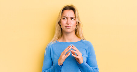 blonde caucasian woman scheming and conspiring, thinking devious tricks and cheats, cunning and...