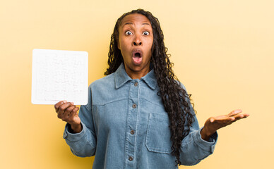 black pretty woman feeling extremely shocked and surprised