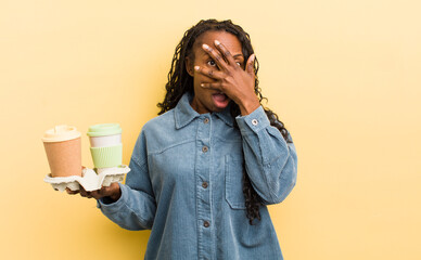 black pretty woman looking shocked, scared or terrified, covering face with hand