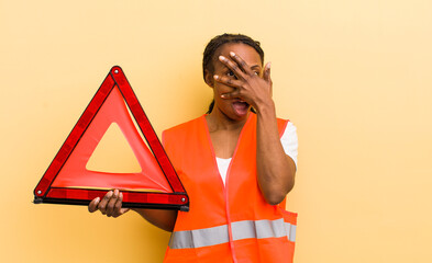 black pretty woman looking shocked, scared or terrified, covering face with hand