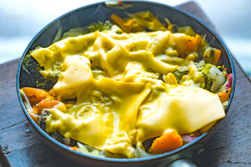 Mixed vegetables dinner, home cooked on a frying pan, steaming vegetables mixed with meat.