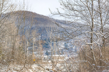 Winter river hike, with fresh snow in morning sunlight, natural outdoors setting, mountains backgrounds, leisure winter activity.