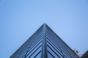Fototapeta na wymiar Windows of modern building office skyscraper with perspective background sky