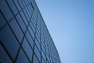 Windows of modern building office skyscraper with perspective background sky
