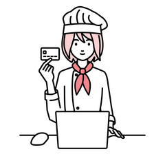 デスクで座ってPCを使いながらクレジットカードを手に持っている調理師の女性