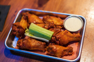 wings and dip on a plate
