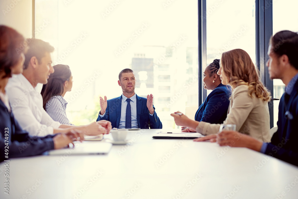 Poster our focus should always be to go bigger and better. shot of a group of businesspeople having a meeti