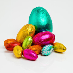 Just waiting to be unwrapped and devoured. Studio shot of a dazzling array of multicolored easter eggs wrapped in foil.