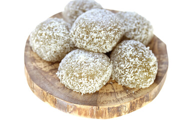 mochi cakes.Coconut mochi on a round board isolated on white background. Japanese traditional dessert with coconut. 