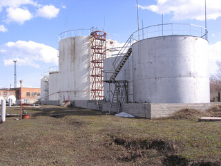 Russia, Novosibirsk 01.01.1980: large storage tanks for industrial fuel at the factory for aviation kerosene reserves in tanks