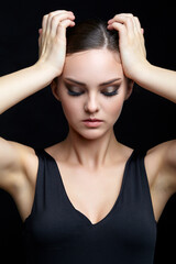 Fototapeta premium Beauty portrait of young woman. Brunette girl with evening female makeup and black dress