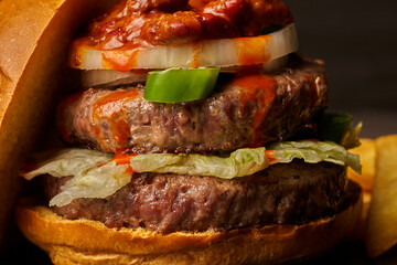 burger with fries onion chili with meat and jalapenos barbecue sauce dark style food