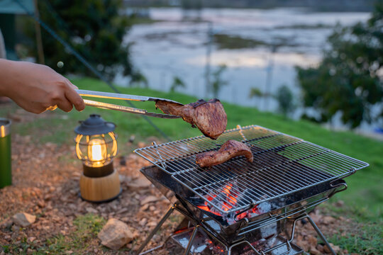Cooking food during camping at natural park in Thailand. Recreation and journey outdoor activity lifestyle.